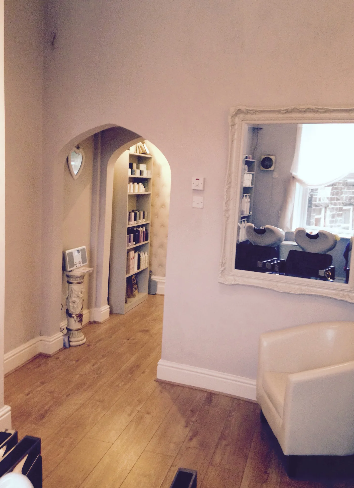 The archway and framed mirror inside Afouro Hair