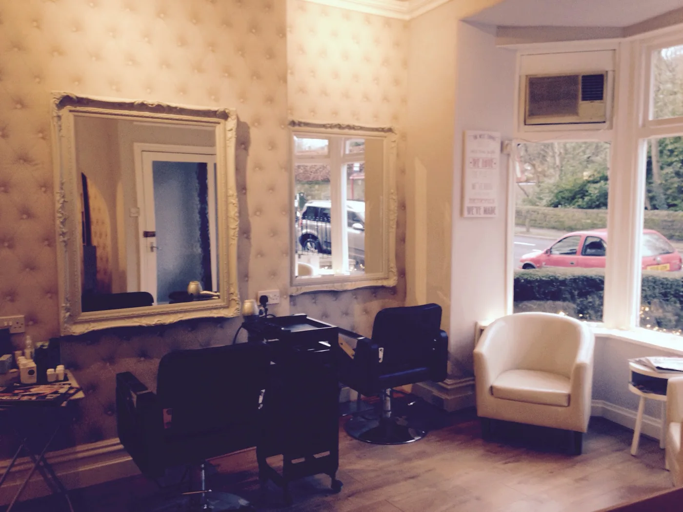 Mirrors and chairs beside the salon's Skipton Road window
